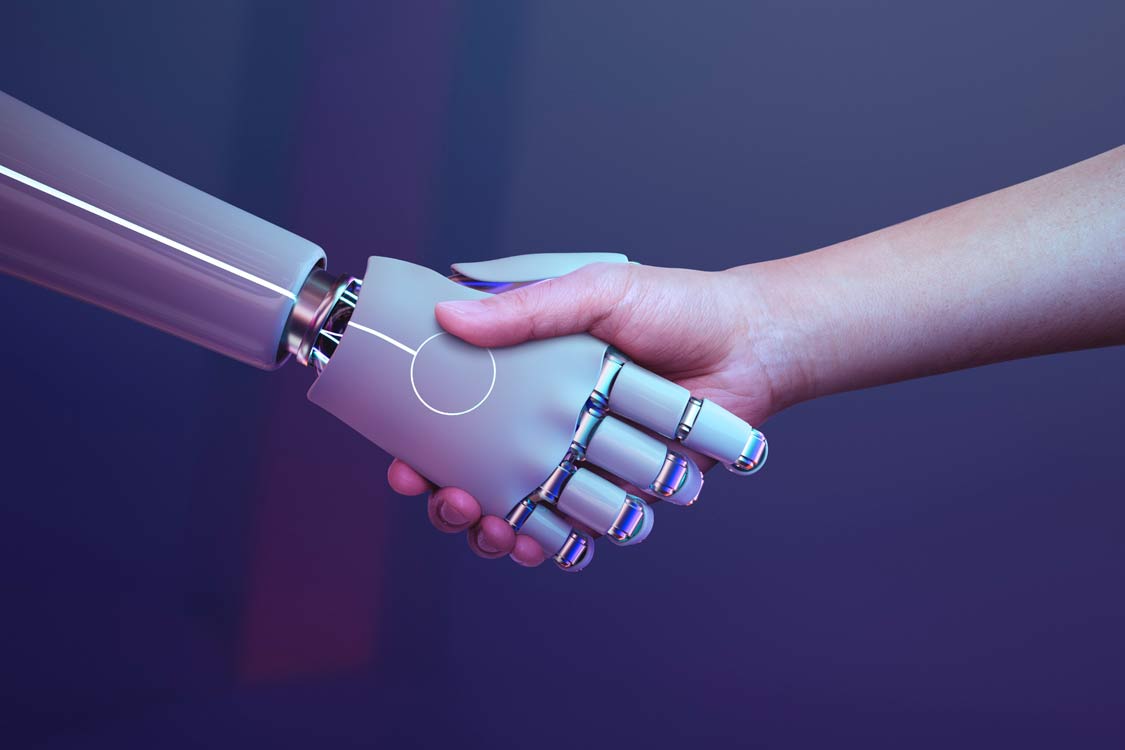 A robotic arm shakes hands with a human arm